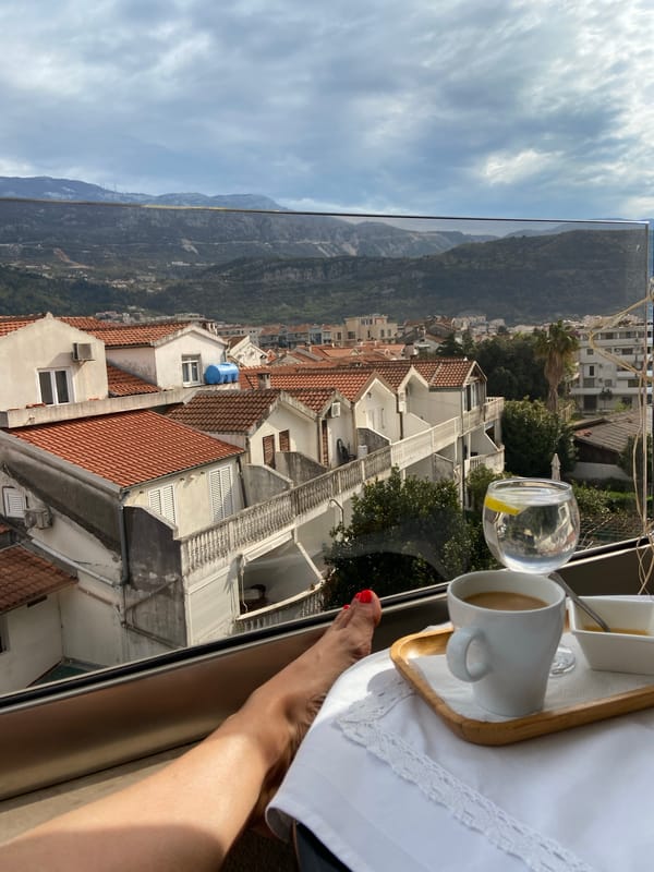 Morning breakfast documented overlooking Budva's Mediterranean coastline