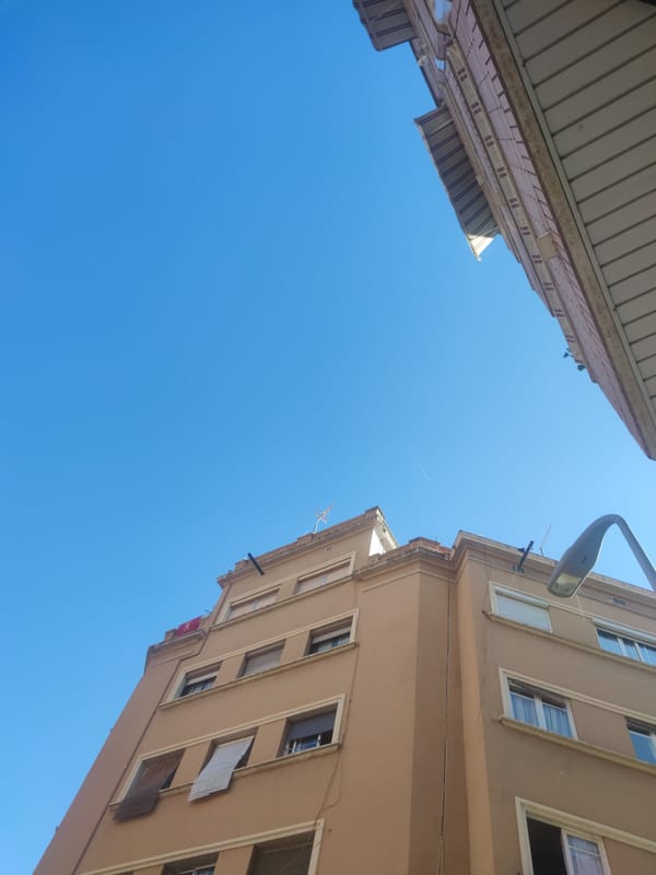 Urban architectural documentation captures building facades under clear skies