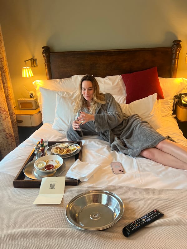 Woman has room service meal at Berlin hotel