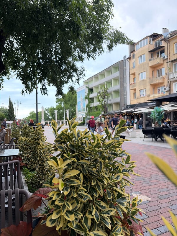 Morning street scene with café seating observed in Varna
