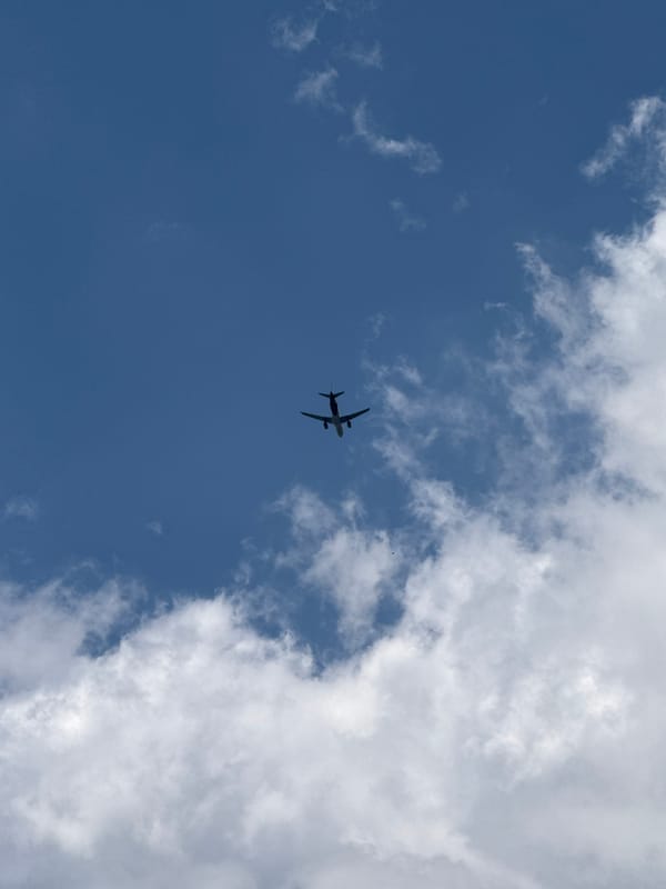 Plane silhouette against blue sky over Sveti Vlas