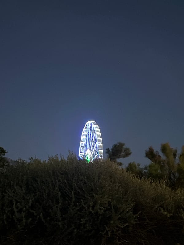 Lit Ferris wheel draws attention during Marseille twilight hours