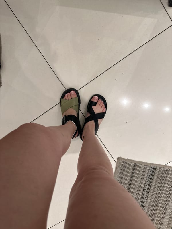 Woman shops for sandals at shoe store in Perm