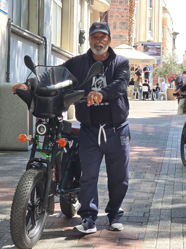 Cyclist observed on sunny street with bicycle