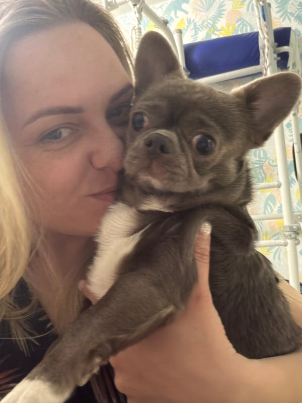 Woman poses with puppies in bedroom in Votkinsk