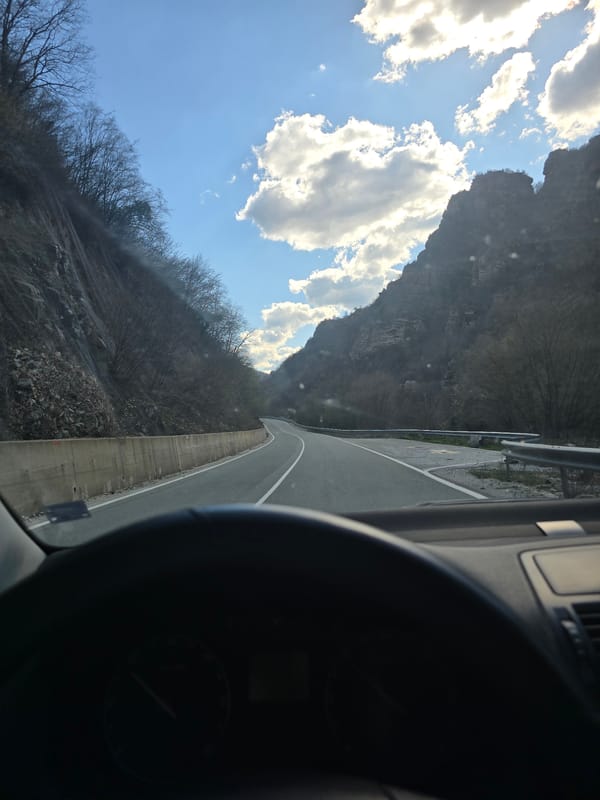 Vehicle travels winding mountain road in Mihalkovo, Bulgaria