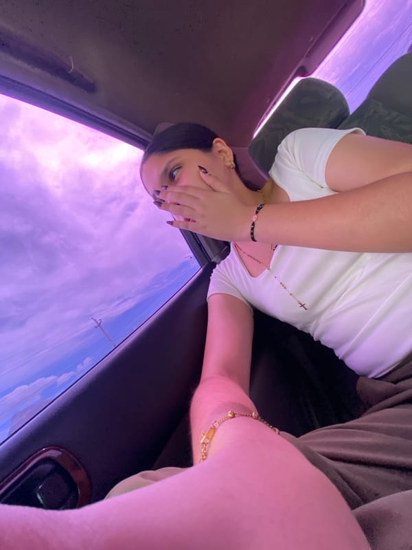 Person in white top observed sitting in vehicle in Porlamar