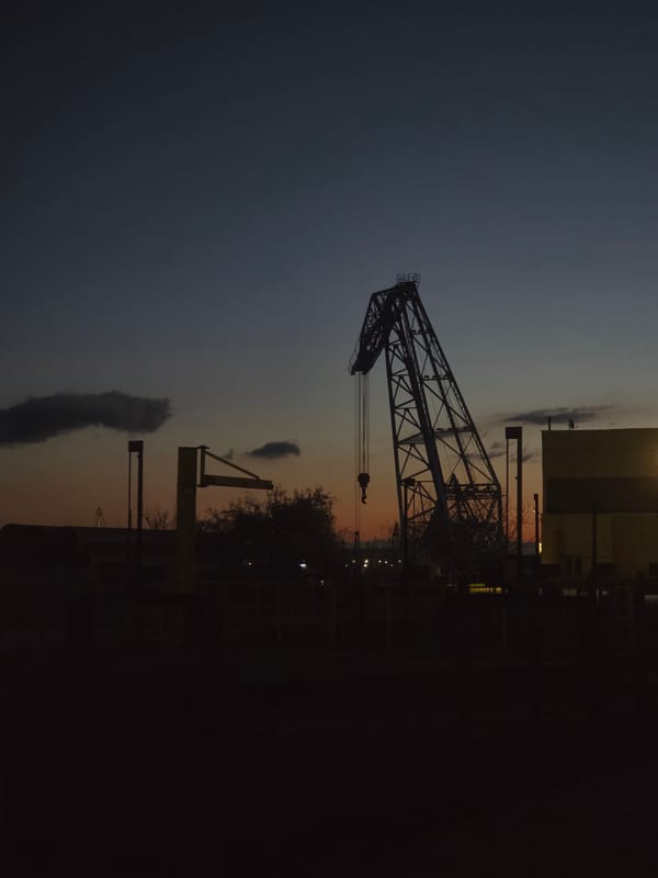 Gantry crane silhouetted against twilight sky in Ruse, Bulgaria