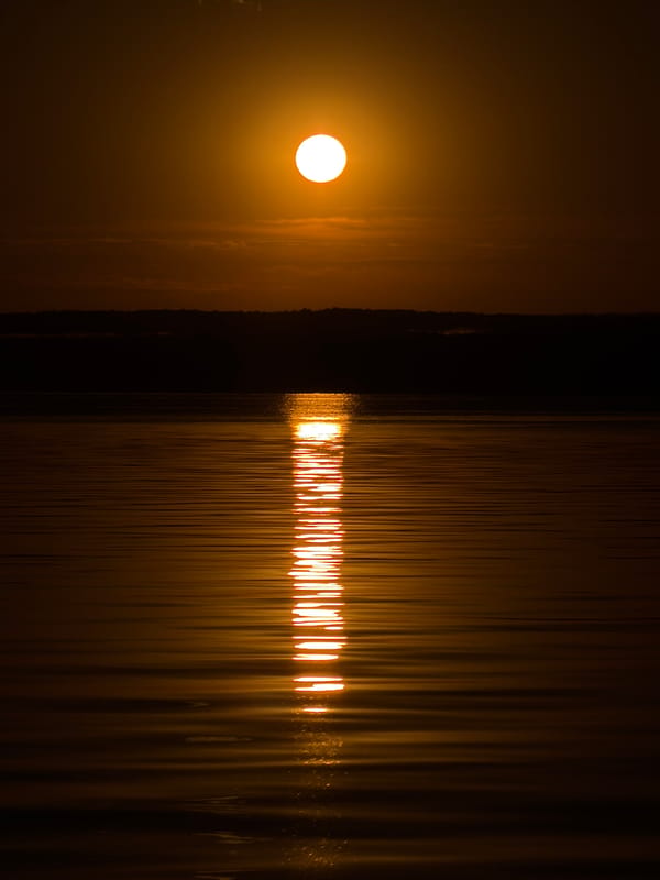Golden sunset stretches across the water in Chaikovsky, Russia