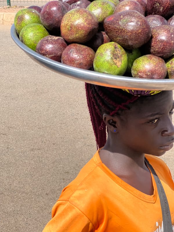 Woman in orange shirt photographed in Bukuru, Nigeria