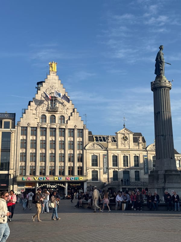 Saxophonist performs in historic Lille square on sunny afternoon