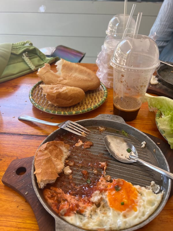 Diners Share Meal at Vietnamese Street-Side Eatery