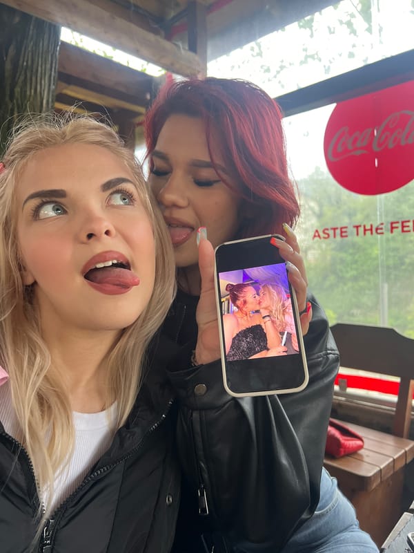 Two women share playful moment at cafe