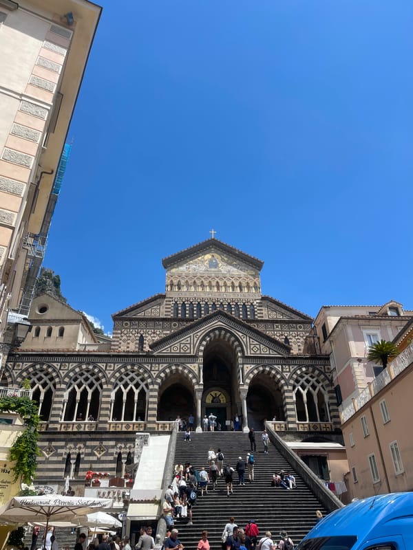 Tourists document Amalfi Cathedral and coastal views in Italy
