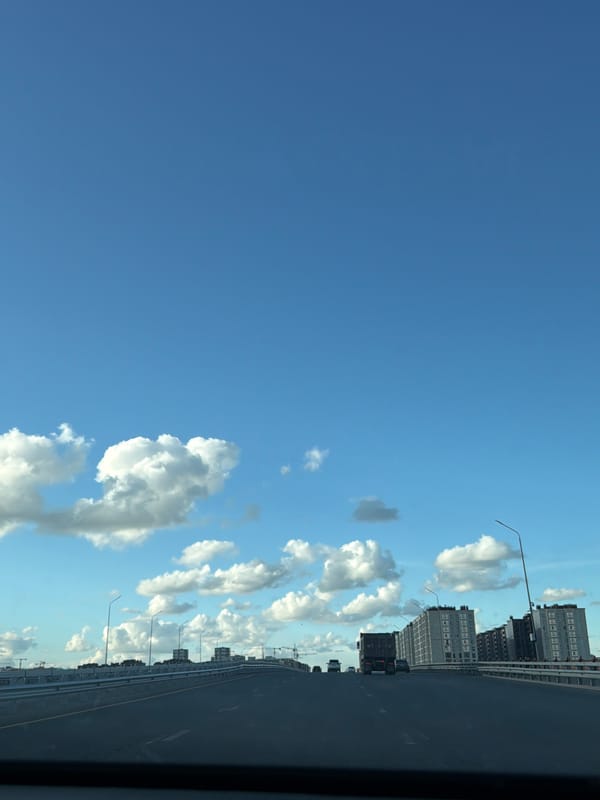On the road through Astana, cranes and city skyline in view