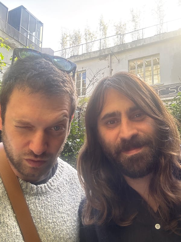Two men take selfie outdoors in Milan