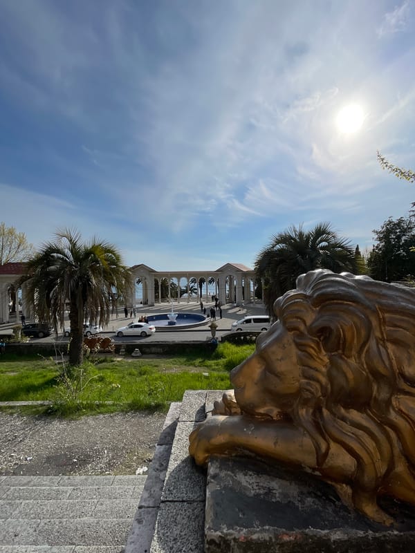 Golden lion statue and classical architecture documented in Abaata