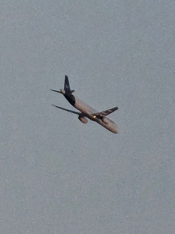 Plane climbing out under gray skies near Frankfurt Airport