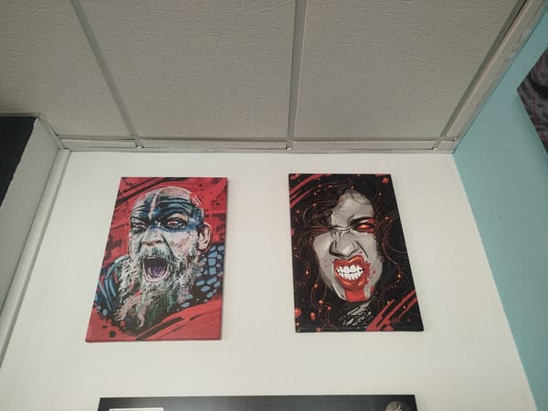 Guitar and art collection displayed on walls in Spain
