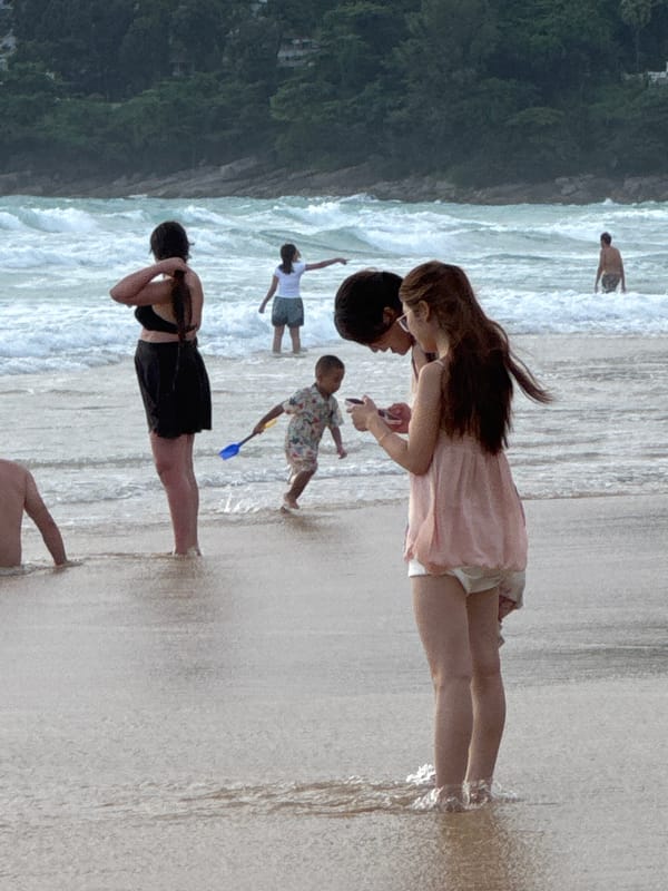 Karon Beach under red flags, surf warnings, and scattered activity