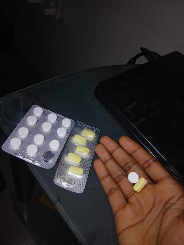 Person photographed handling pills and Nigerian currency