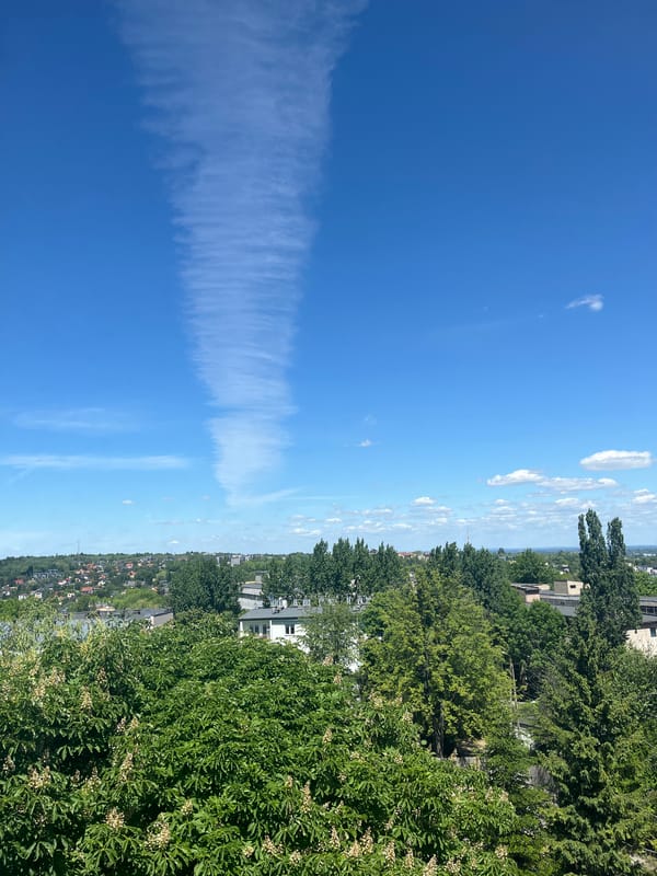 Aircraft contrail observed across urban skies amid everyday moments