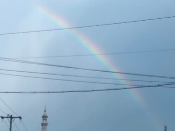 Rainbow appears over Medan streets during overcast morning