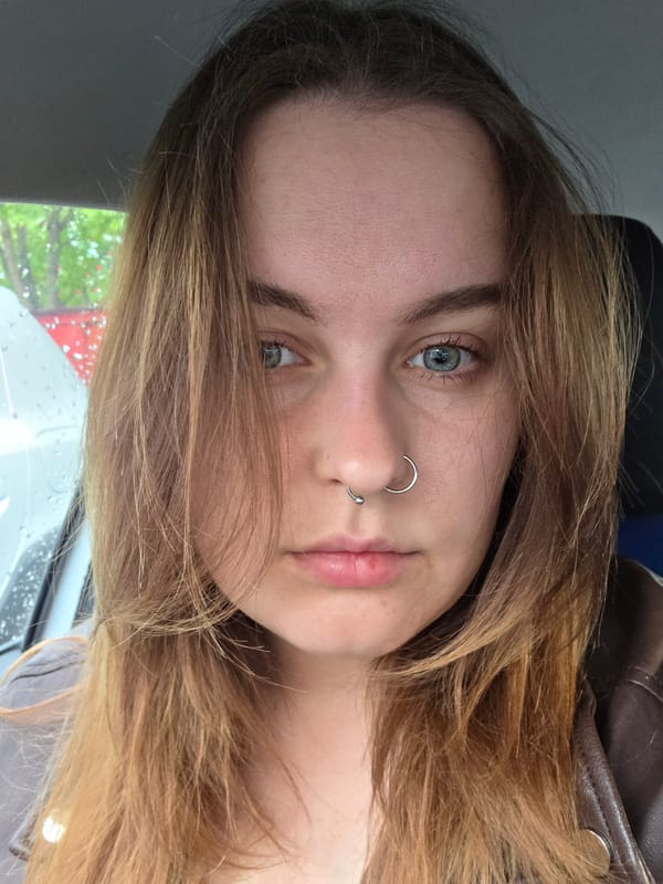 Woman photographed in car interior during rainy morning