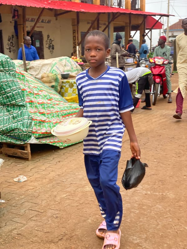 Morning foot traffic through a street market in Kafanchan B