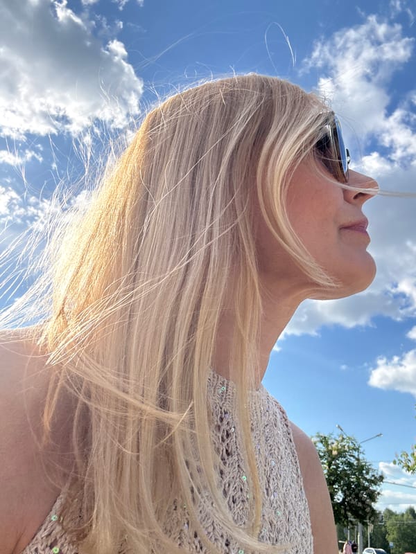 Woman gazes skyward during sunny afternoon in Minsk