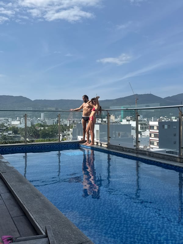 Swimmers pose at rooftop infinity pool overlooking Đà Nẵng