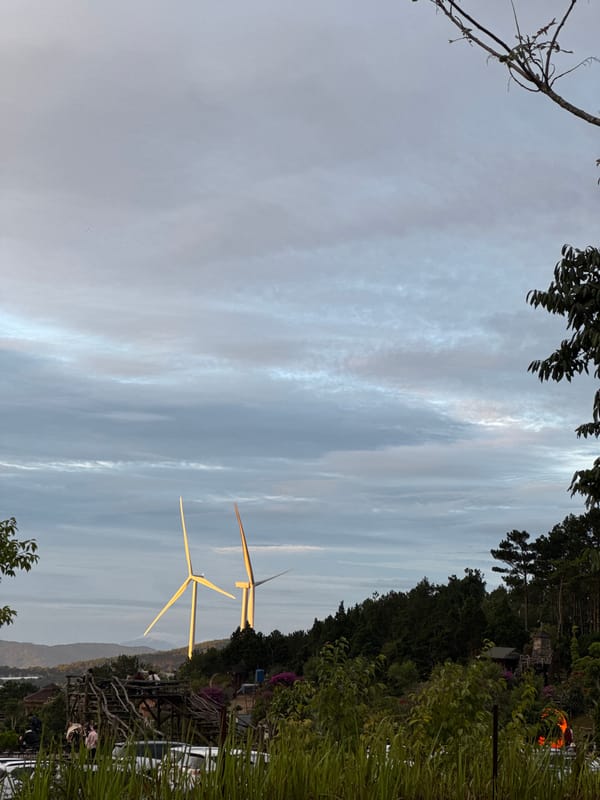Wind turbines operational near Phát Chi, Vietnam at dusk