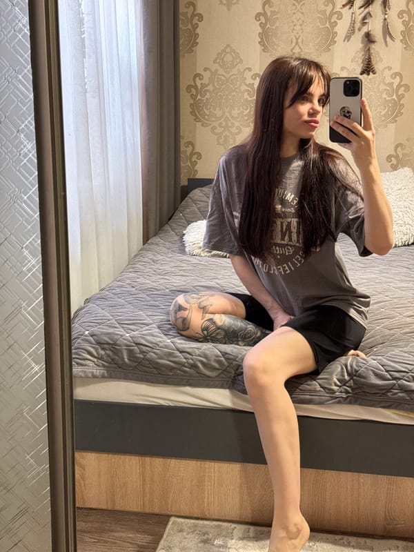 Woman documents morning routine with cat in Rostov-on-Don bedroom