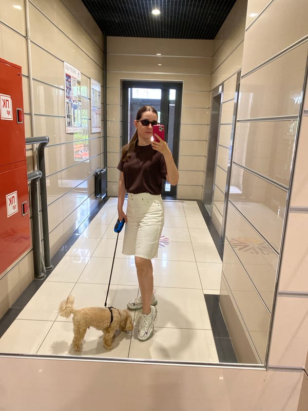 Mirror selfie in a reflective tiled hallway, Sankt-Peterburg