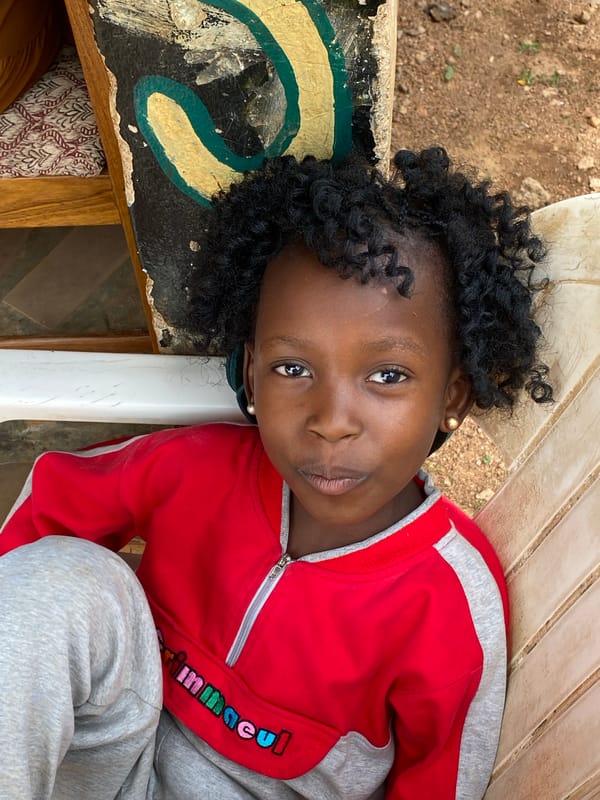 Child in tracksuit photographed outdoors in Kuru Karama, Nigeria