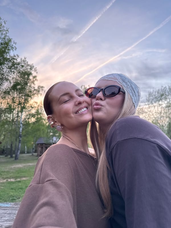 Friends photograph together, duck spotted near water in Chaikovsky