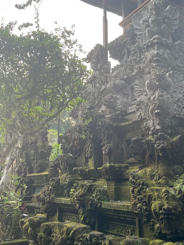 Ancient moss-covered temple carvings documented in Tegallalang, Indonesia