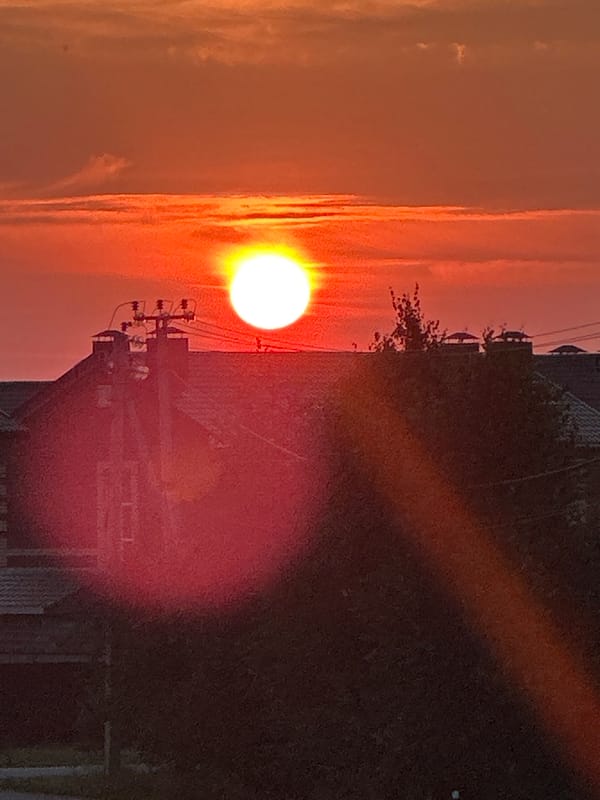 Vivid summer sunset over Zubovo's residential streets
