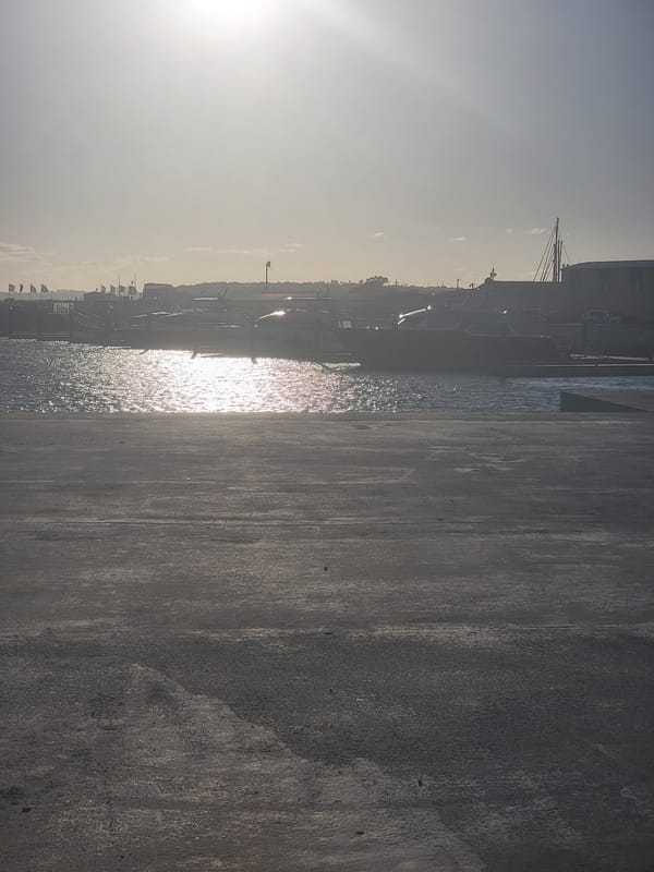 Luxury yachts fill Quarteira marina on a sunny evening