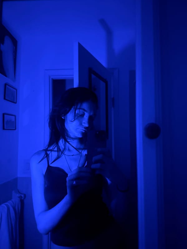 Woman observed under blue lighting in New York interior
