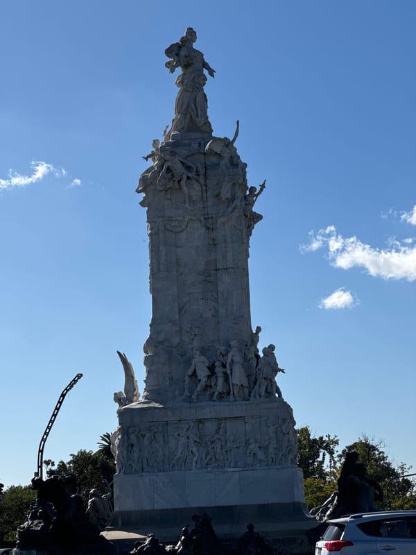 Busy street life documented around ornate Buenos Aires monument