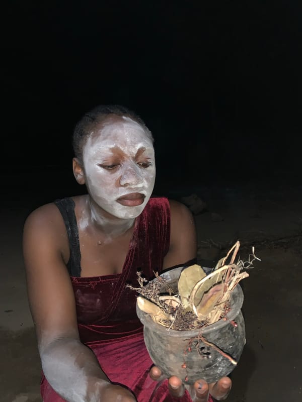 Traditional healer holds plant materials in Nigerian village