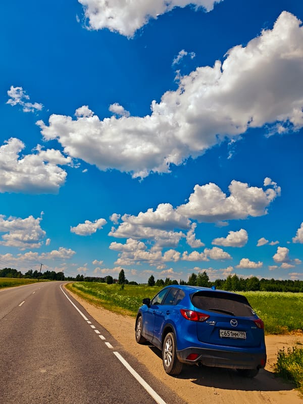 Blue SUV parked on rural road in Kurovo, Russia