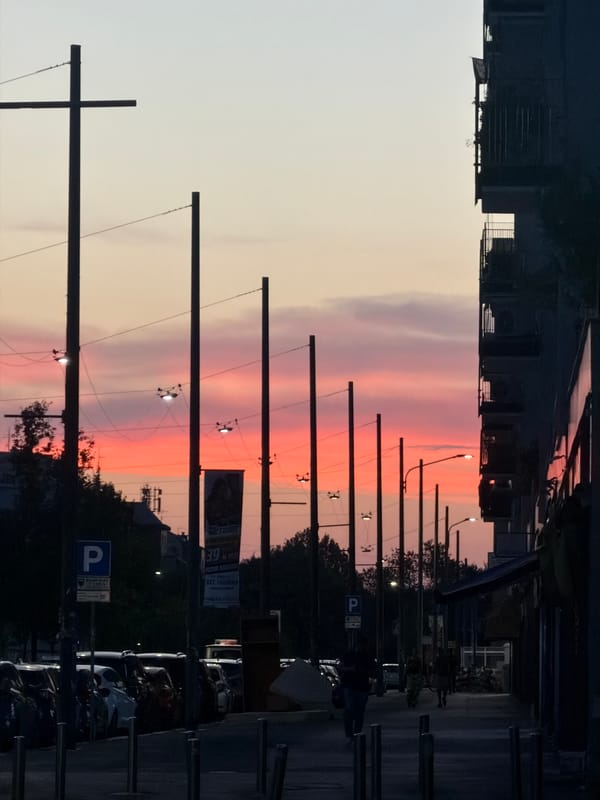 Milan sunset scene with crescent moon and vertical light column