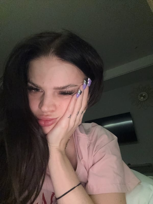 Purple acrylic nails on display in a Hanoi home setting