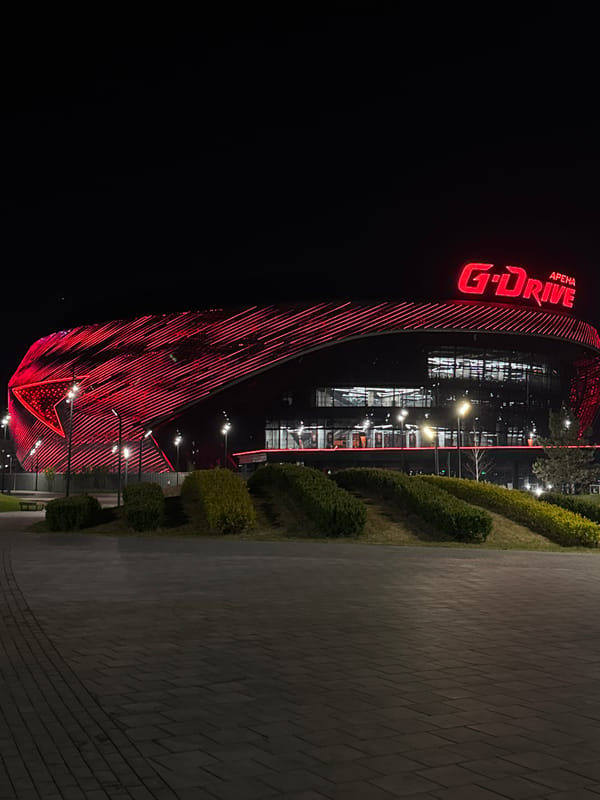 G-Drive Arena illuminated in red neon lights at night