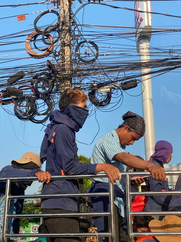 Utility crew maintains power lines in Wichit, Thailand