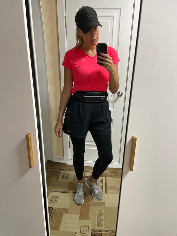 Woman takes mirror selfie in athletic wear in Baranovka