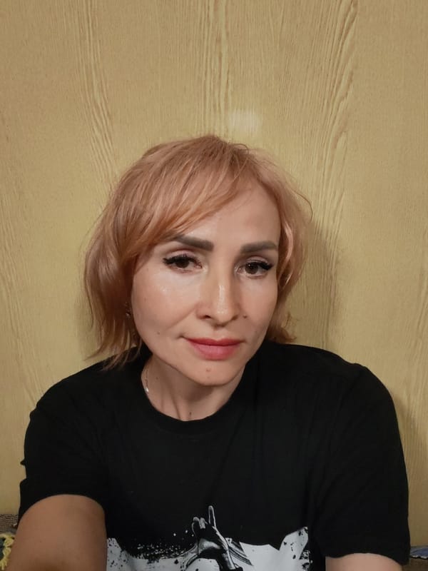 Bold pink hair and graphic tee in a close-up portrait