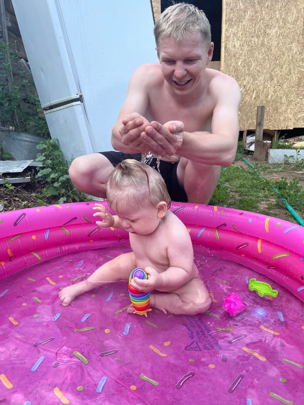 Baby plays in a sprinkle-donut kiddie pool in Fokino